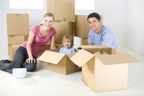 Removal team using safe lifting practices during a house move