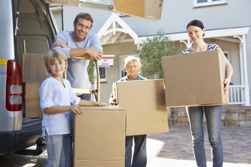 Packed moving boxes and furniture prepared for transport by local removals company