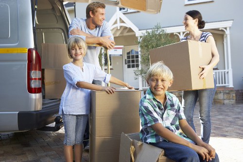 Packed boxes and furniture prepared for transport by a man with van
